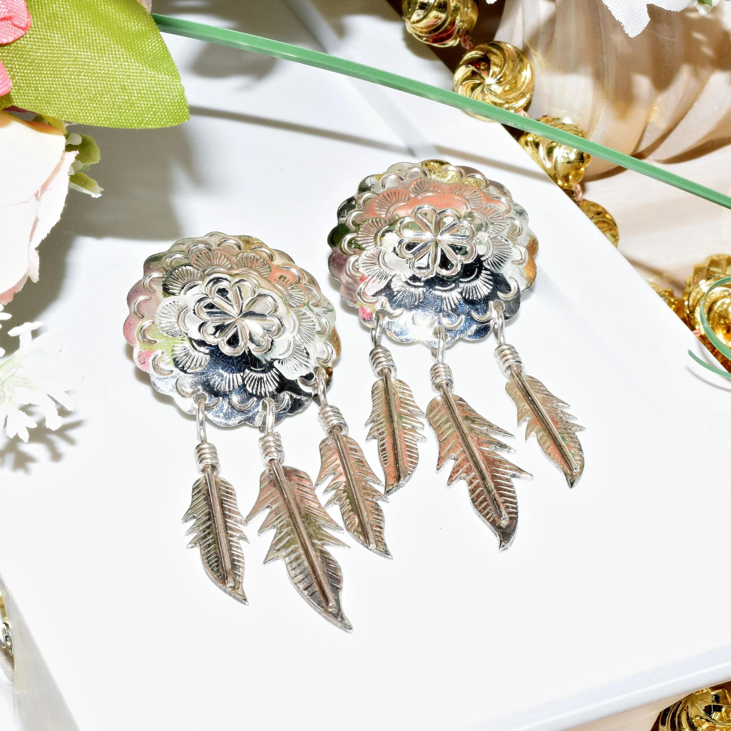 A pair of vintage earrings shaped like dream catchers